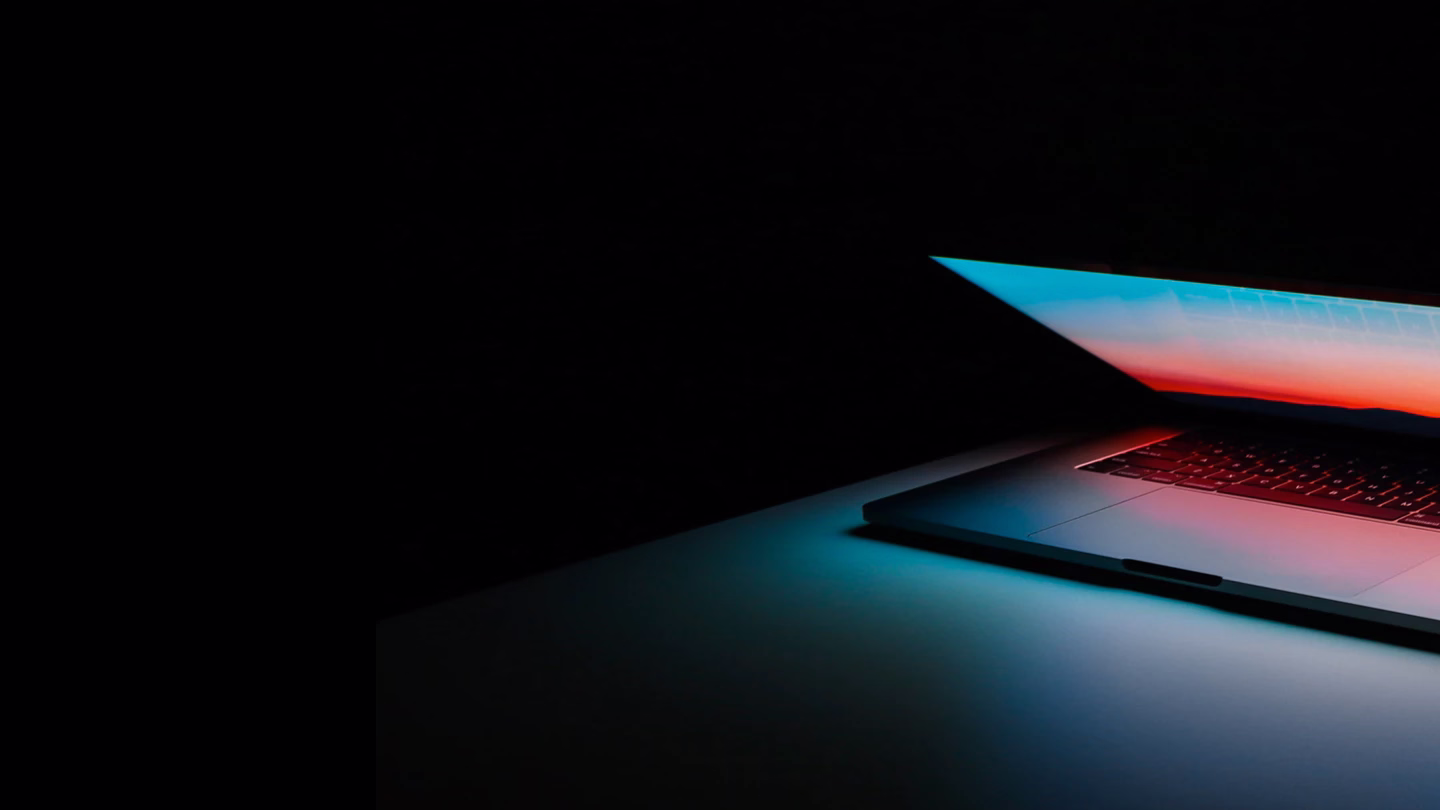 Laptop glowing in a dark room